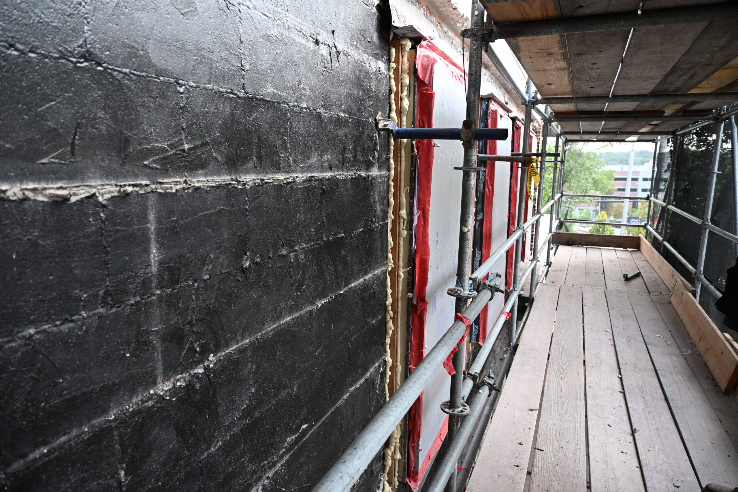 Picture from scaffolding of Main St. exterior wall with brick siding removed