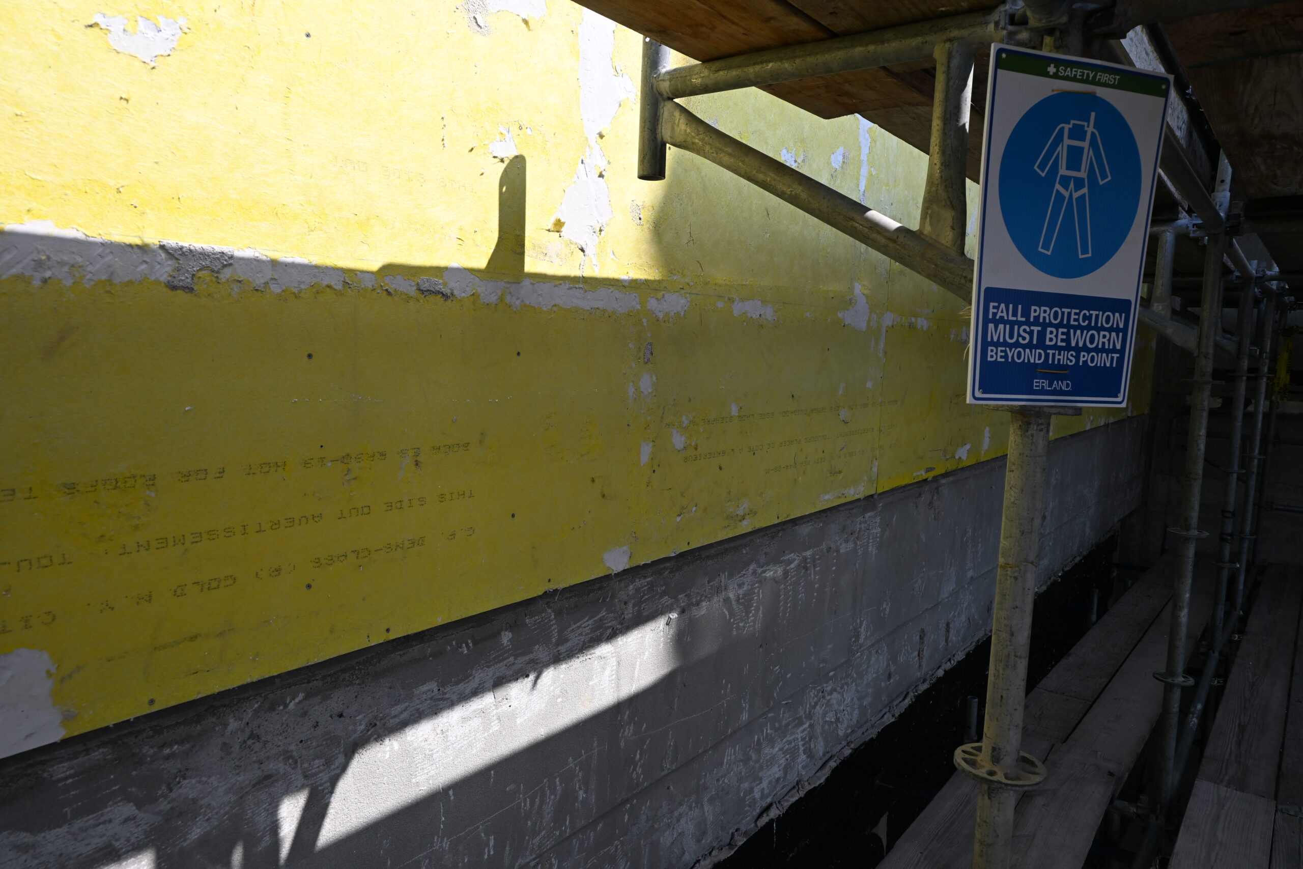 Picture from scaffolding of Main St. exterior wall with "stucco" siding removed