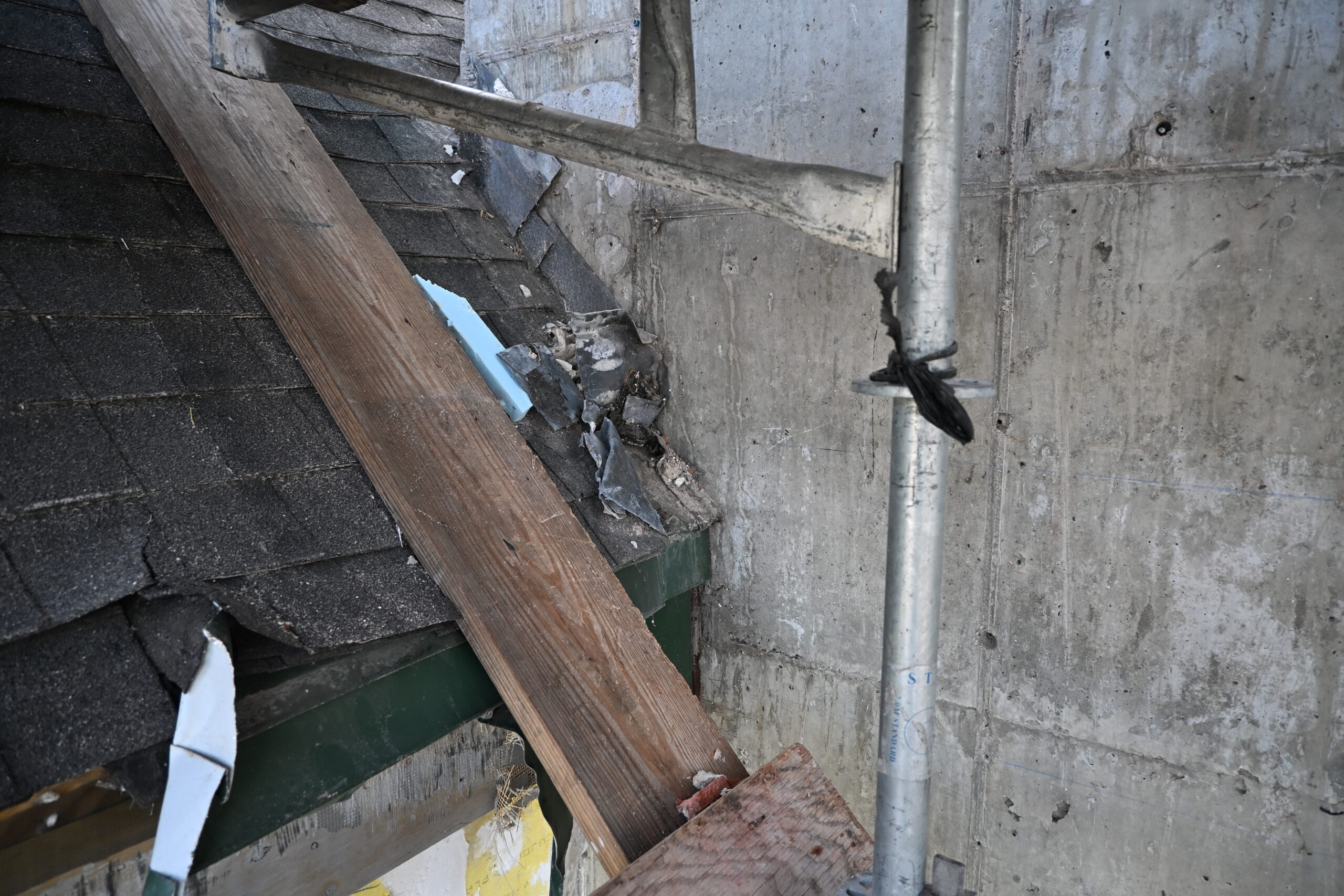 Picture of compromised roof shingles to be replaced in renovation