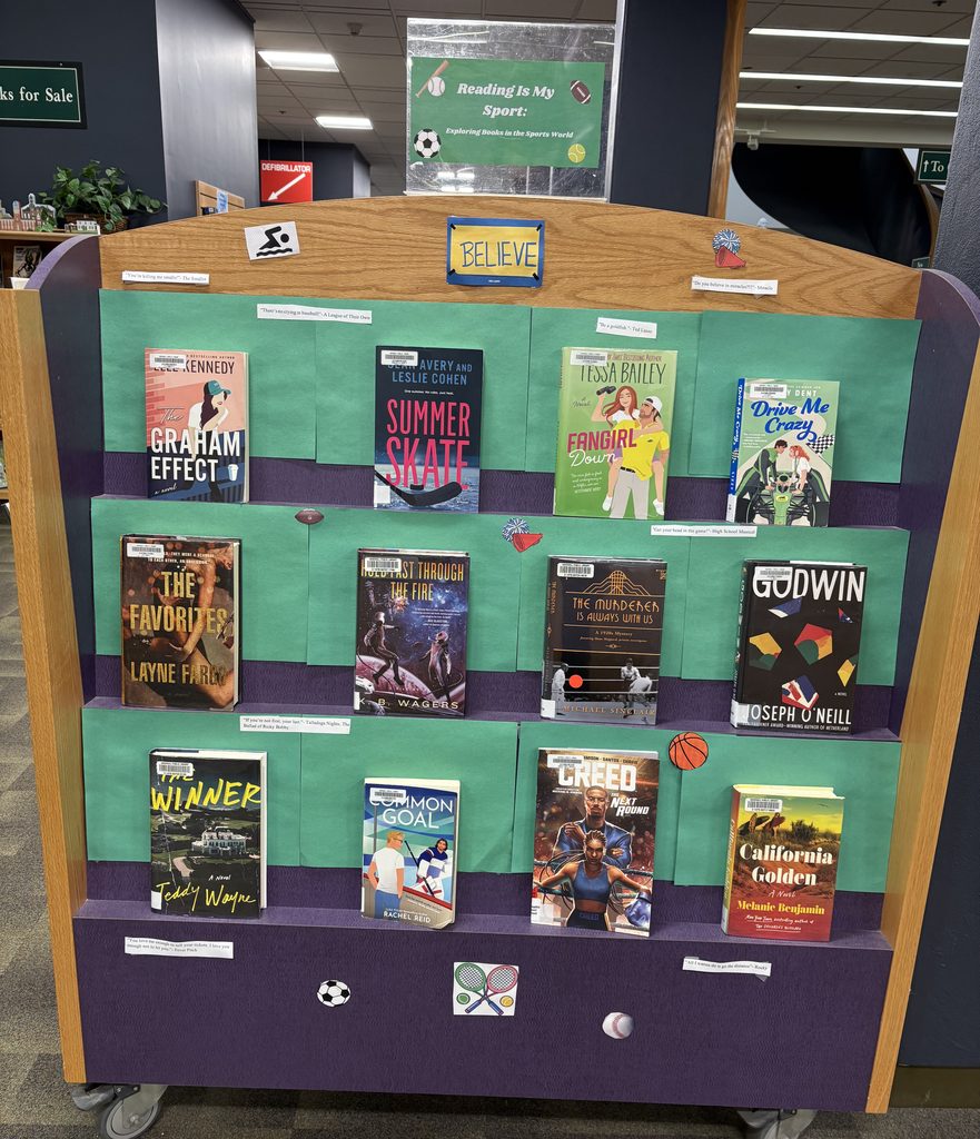 Books on display with sign at top saying "Reading Is My Sport: Exploring Books in the Sports World"